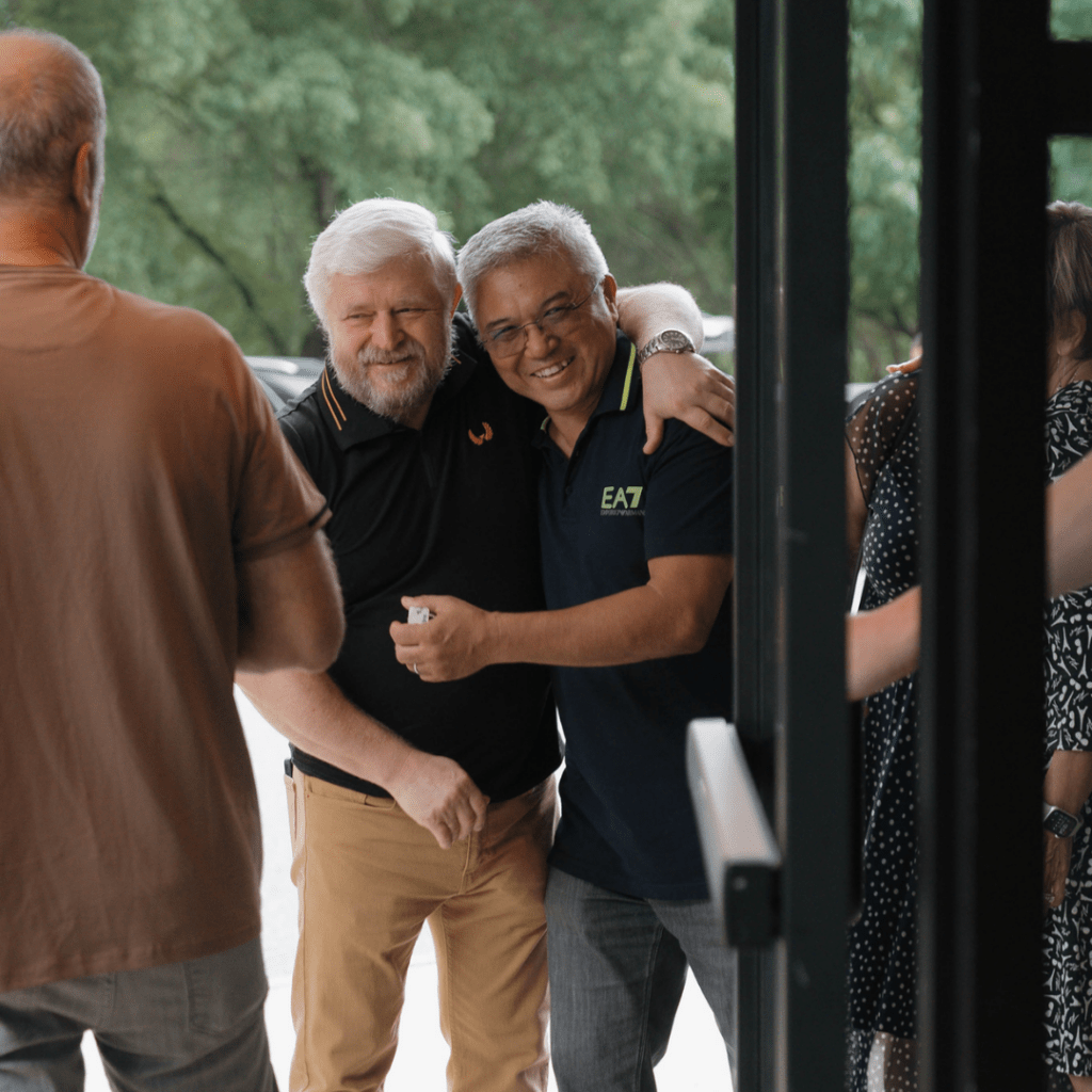 an image of two old men happily embracing each other
